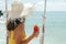 Girl drinking cocktail and hangig on swings in beach cafe on tropical island