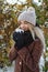 Girl drinking hot tea outdoors in winter