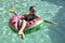 Girl drinking orange juice on watermellon float