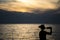 Girl drinking wine at the beach during sunset