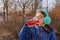 Girl drinks from a bottle in the street. A teenage girl in headphones and glasses