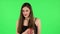 Girl drinks unpalatable coffee and is disgusted on green screen