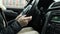 Girl driving her car in motion close up, hands on the steering wheel