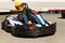Girl driving kart at racing track outdoors