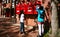 Girl dropping a letter in a red postbox