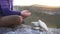 Girl drops a pyramid of stones close up at sunset