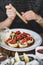 Girl eating baked sushi with chopsticks at Japanese restaurant