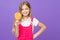 Girl eating big candy on stick or lollipop. Sweet childhood concept. Kid with long hair likes sweets and treats. Girl on