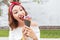 Girl eating big ice cream with blueberry flavor outdoors