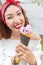 Girl eating big ice cream with blueberry flavor outdoors
