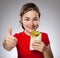 Girl eating big sandwich showing OK sign