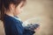 The girl eating blueberries from a glass bowl