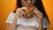 Girl eating burger, enjoying fast food, high calorie nutrition, risk of obesity