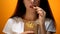 Girl eating french fries, enjoying fast food, high calorie meal, risk of obesity