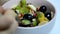 girl eating fruit salad. Diet, healthy fruit salad in the white bowl - healthy breakfast, weight loss concept