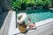 Girl eating fruits in pool on luxury villa in Bali