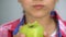 Girl eating green apple, smiling with white healthy teeth, dental care concept