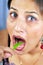 Girl eating green chilly