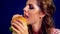 Girl eating hamburger.