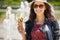 The girl is eating ice cream. Background fountain