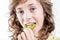 Girl eating a kiwi slice