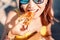 Girl eating Mexican fast food quesadilla on the beach. Healthy and tasty snack