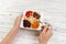 The girl is eating oatmeal with dried fruit. Useful and healthy breakfast. dark wooden background, top view