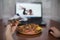 Girl eating pizza and watching exercise for weight loss