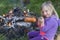 Girl Eating Sausage Cooked On Camp Fire