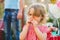 Girl Eating Sausage At Family Barbeque. 2 years old girl eats sausage