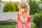 Girl Eating Sausage At Family Barbeque. 2 years old girl eats sausage