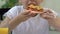 Girl eating stale deep-fried pizza, unhealthy junk food, risk of obesity