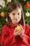 Girl Eating Star Shaped Cookie In Front Of Tree