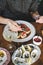 Girl eating sushi and fresh oysters in Japanese restaurant