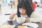 Girl eating Tempura Rice Bowl