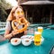 Girl eating traditional Pretzel and drinking fresh Bavarian beer in beer garden in Munich. The concept of traditional food