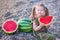 Girl eating watermelon on the beach, summertime enjoying beautiful day close to ocean