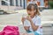 A girl eats a homemade sandwich in the schoolyard. Nutrition for children during their studies. Healthy lunch or snack