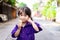 Girl eats an ice cream cone. Child with dirt black nails holding food. Students smile sweetly. Children are 3 years old.