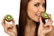 The girl eats a kiwi