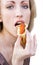 Girl eats a pancake with red caviar