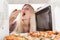 Girl eats pizza out of the microwave