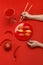 The girl eats sushi on a red plate. Creative concept of restaurant table setting