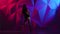 Girl elegant dance twerk in shorts on bright graphic background. Slow motion