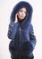 Girl elegant lady wear fashionable coat jacket with furry hood. Luxurious fur. Girl posing hooded fur coat. Female with