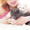 Girl embraces two cats