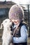 Girl embracing a goatling.