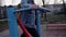 The girl is engaged in a foot simulator on the Playground in the city Park. The camera shows a panorama of the girl`s body and leg