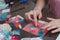 The girl is engaged in making greeting cards at home. Using paper, lace, braid and other materials.