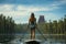 Girl engages in stand-up paddleboarding on a serene varnish